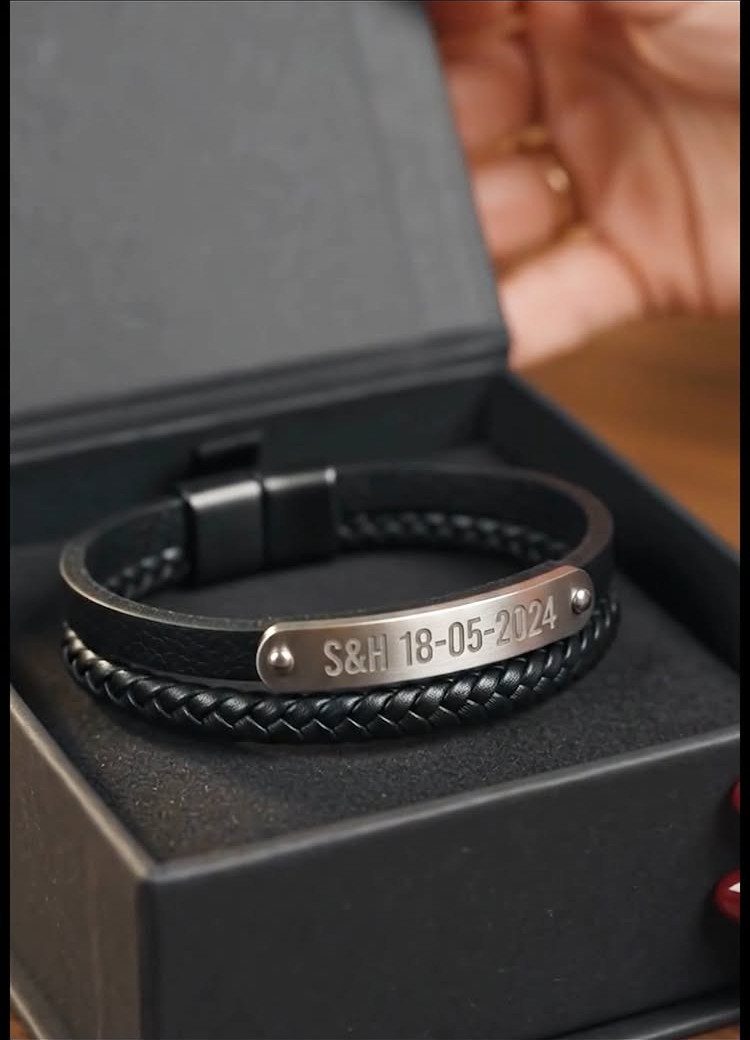 17 Anniversary Boyfriend Gifts He'll Actually Use (2026) 17 Black braided leather bracelet with engraved silver date plate in a black box