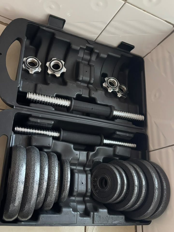 13 Ideas for a Birthday Gift for a Man Who Has Everything 11 Adjustable dumbbell set with weights and bars in a black plastic carrying case.