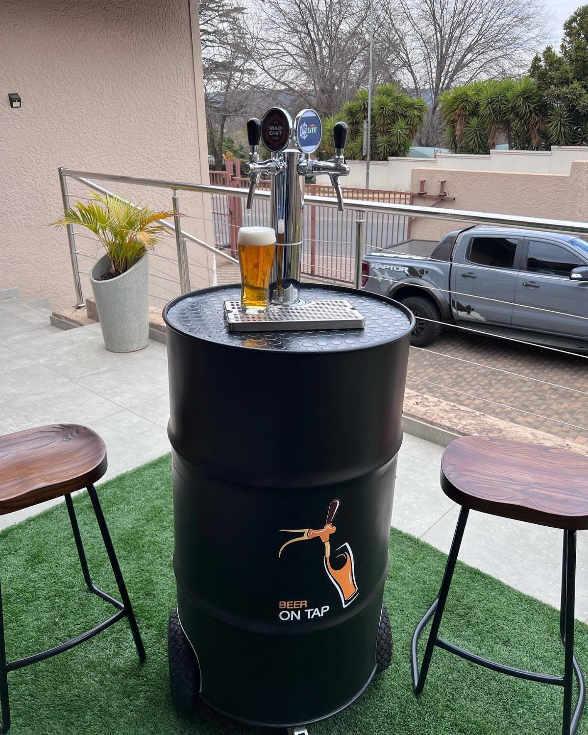 13 Ideas for a Birthday Gift for a Man Who Has Everything 4 Beer keg table with a draft beer tap and a glass of beer.