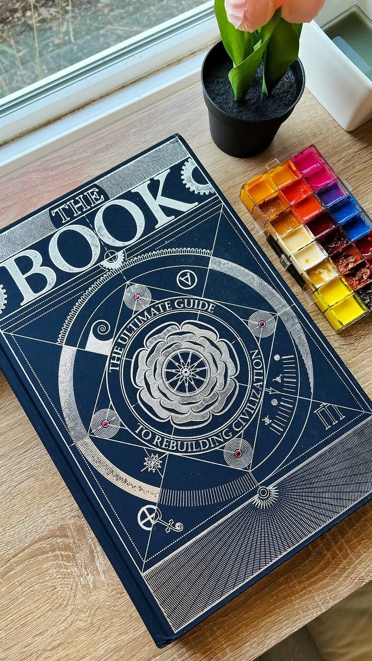 13 Ideas for a Birthday Gift for a Man Who Has Everything 1 The Book: The Ultimate Guide to Rebuilding Civilization on a wooden table.