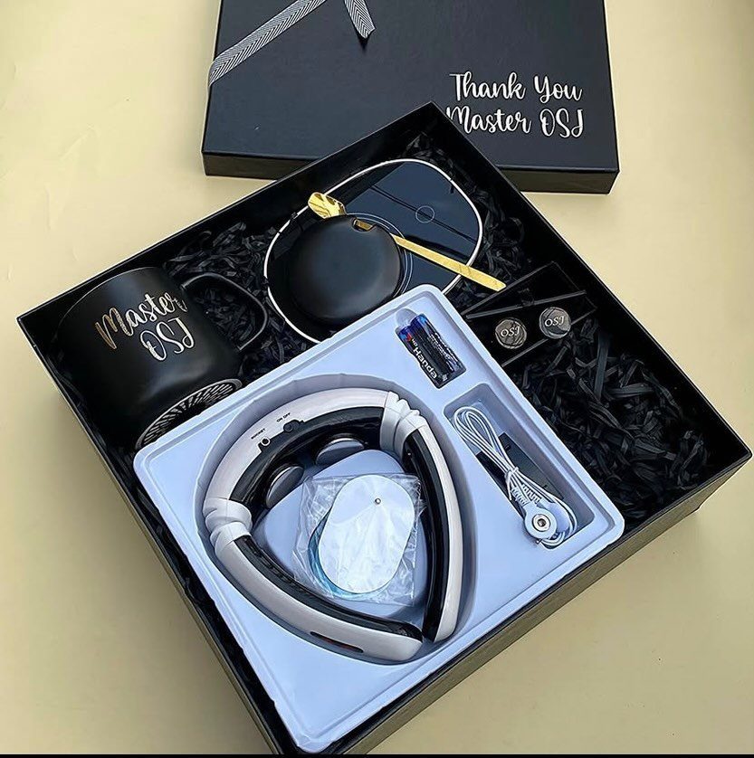 13 Ideas for a Birthday Gift for a Man Who Has Everything 7 Black gift box with a personalized mug, white headphones, and office accessories.