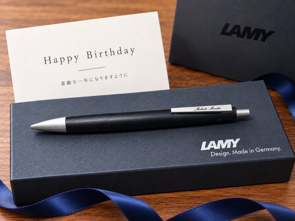 13 Ideas for a Birthday Gift for a Man Who Has Everything 6 Black Lamy pen on a blue gift box with a Happy Birthday card.