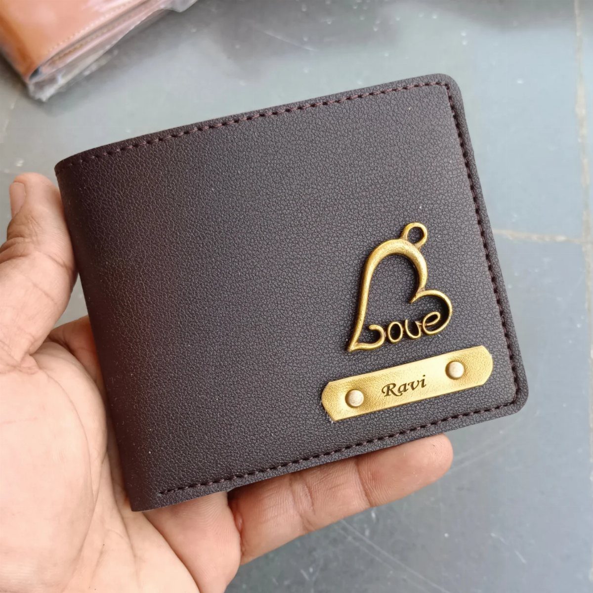 13 Ideas for a Birthday Gift for a Man Who Has Everything 3 Brown leather wallet with a gold heart charm and personalized name plate Ravi.