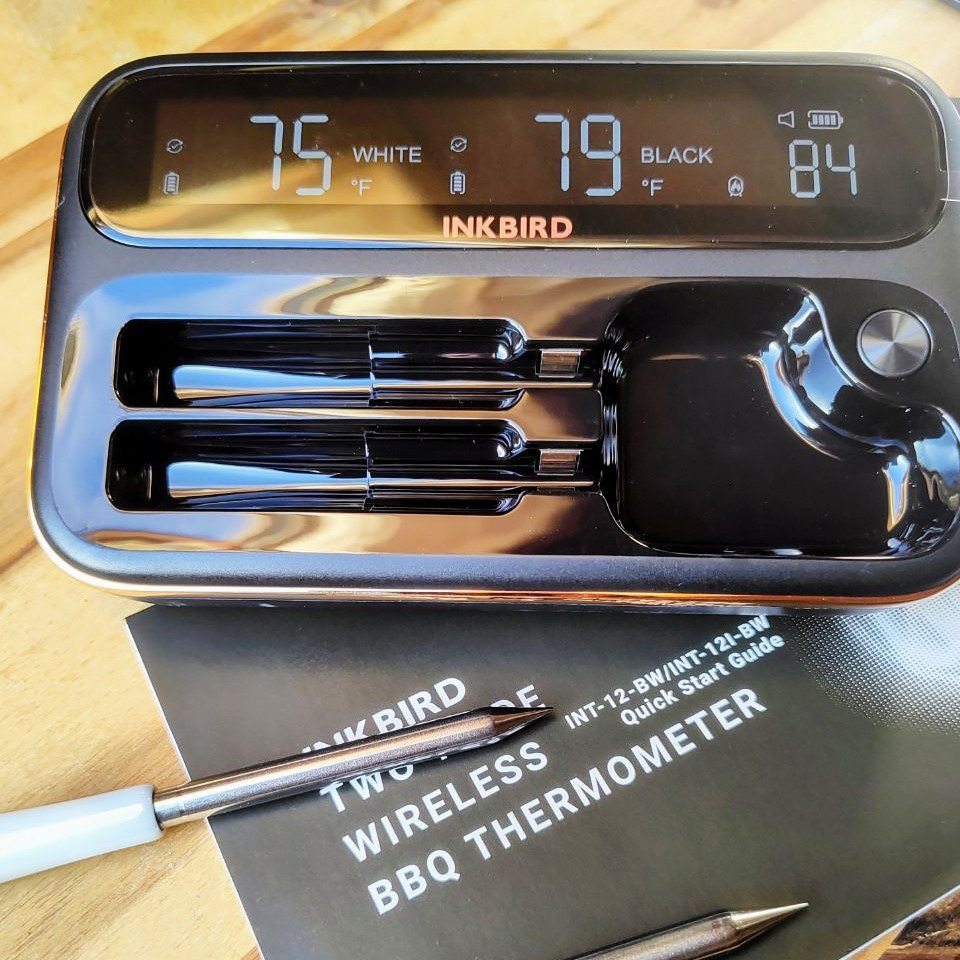 13 Ideas for a Birthday Gift for a Man Who Has Everything 8 Inkbird wireless BBQ thermometer with digital display, probes, and manual on wooden table