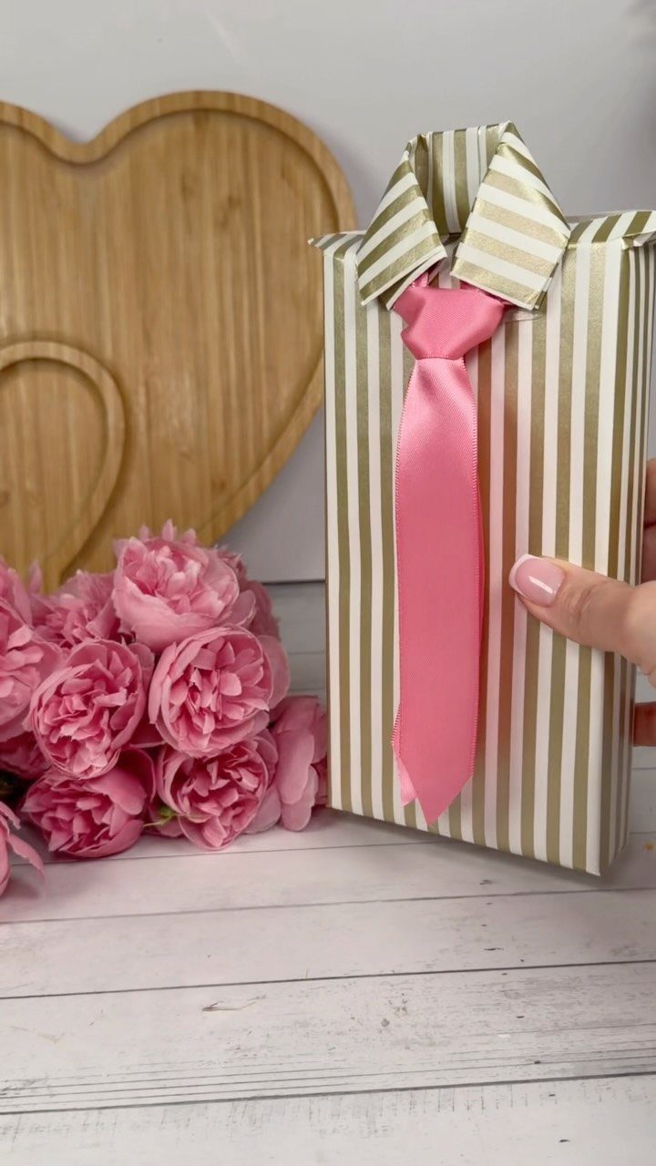 Birthday Gift Wrapping Ideas: 9 Ways to Wrap a Present 8 Gift wrapped in striped paper with a pink ribbon tie and pink peonies.