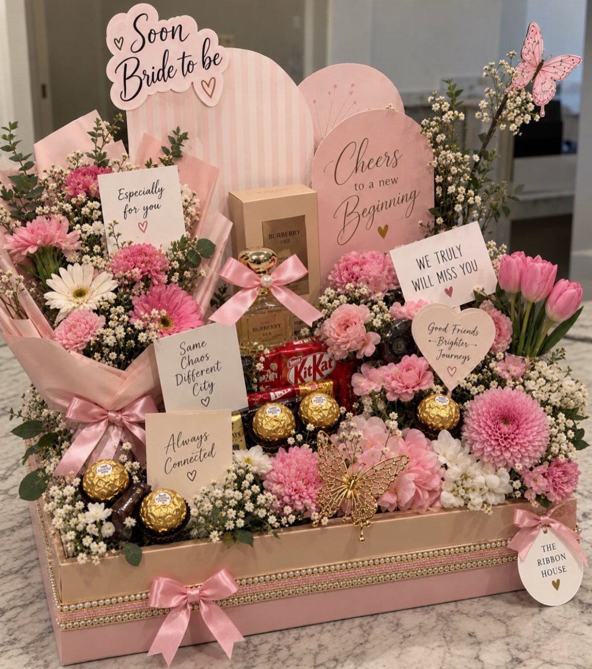 11 Bridal Shower Gift Basket Ideas for Every Bride-to-Be 5 Pink bridal gift box with flowers, chocolates, perfume, and 'Soon Bride to be' sign.