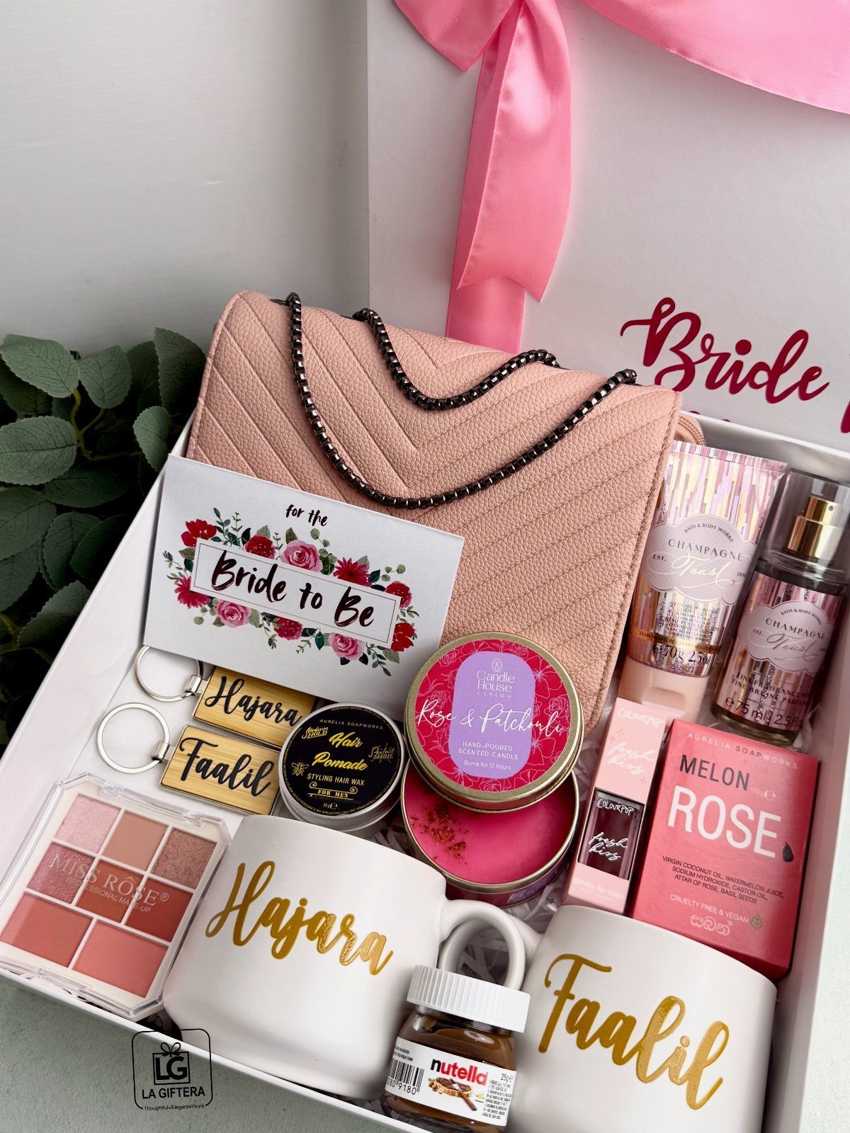 11 Bridal Shower Gift Basket Ideas for Every Bride-to-Be 6 Bridal gift box with personalized mugs, pink clutch, and beauty products for a bride.