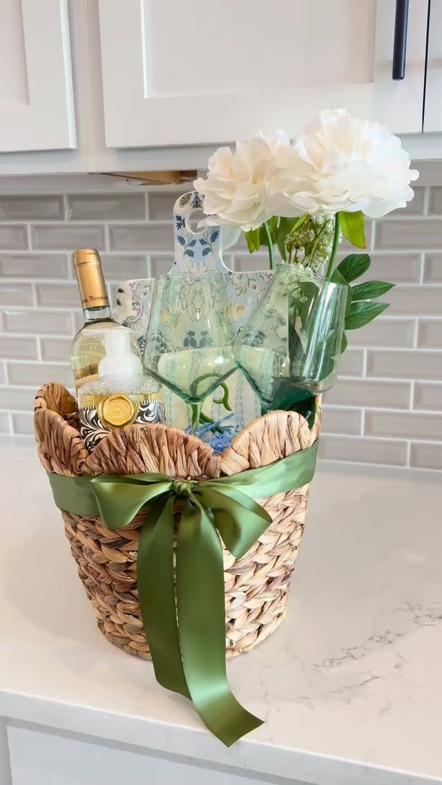 11 Bridal Shower Gift Basket Ideas for Every Bride-to-Be 2 Woven gift basket with white wine, green glasses, and white peonies with green ribbon.