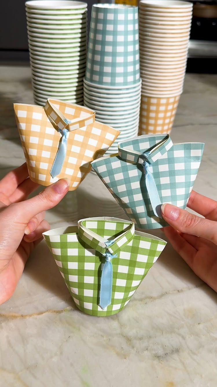 9 Cheap Fathers Day Gifts with Handmade and Easy Ideas 7 Paper gift boxes folded like collared shirts with blue ribbon ties on marble.