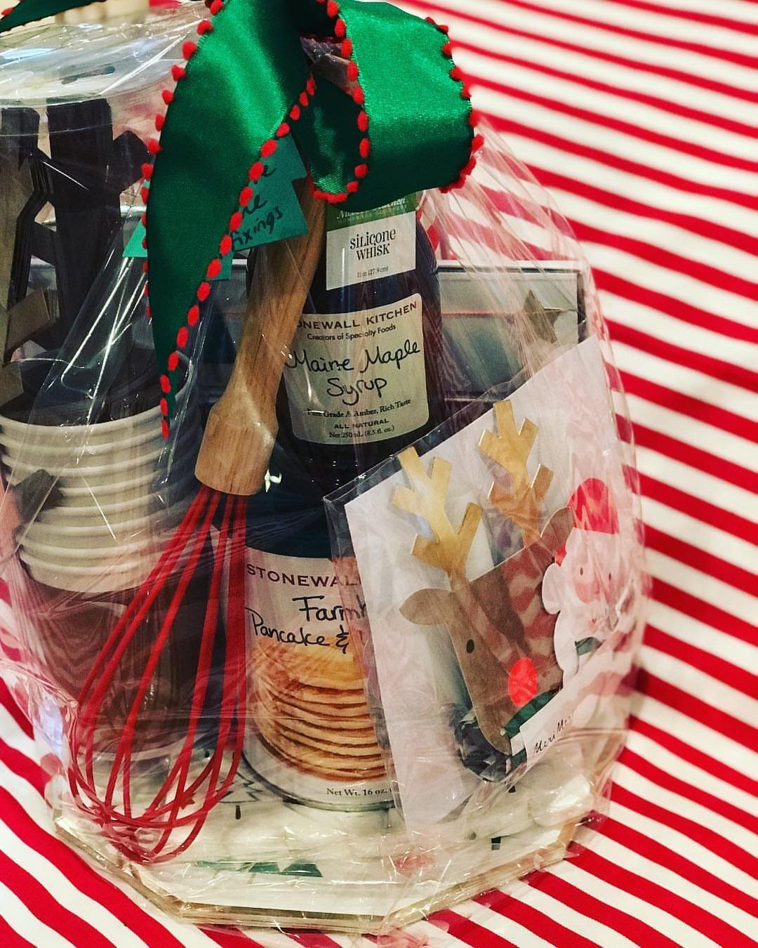 Christmas Food Basket Gift Ideas: 10 Options to Give 8 Breakfast gift basket with maple syrup, pancake mix, and red whisk wrapped in cellophane.
