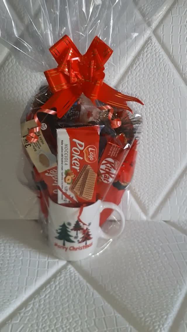 Christmas Food Basket Gift Ideas: 10 Options to Give 2 Chocolate bars in a Christmas mug wrapped in cellophane with a red bow.