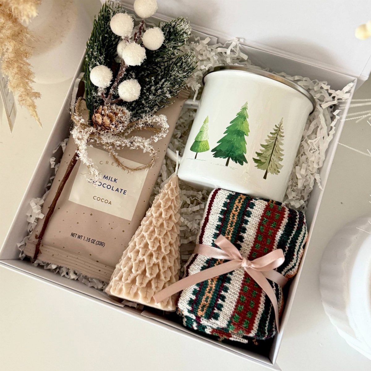 Christmas Food Basket Gift Ideas: 10 Options to Give 9 Hot cocoa gift box with chocolate bar, pine tree mug, and knitted accessories.