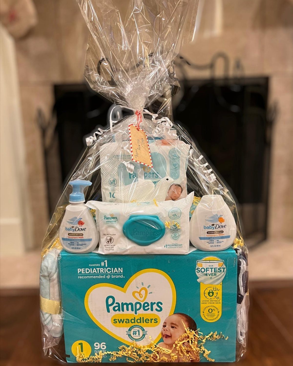 Christmas Gift Baskets for Family: 7 Ideas for Every Age 7 Baby gift basket with diapers, wipes, and lotion wrapped in clear cellophane.