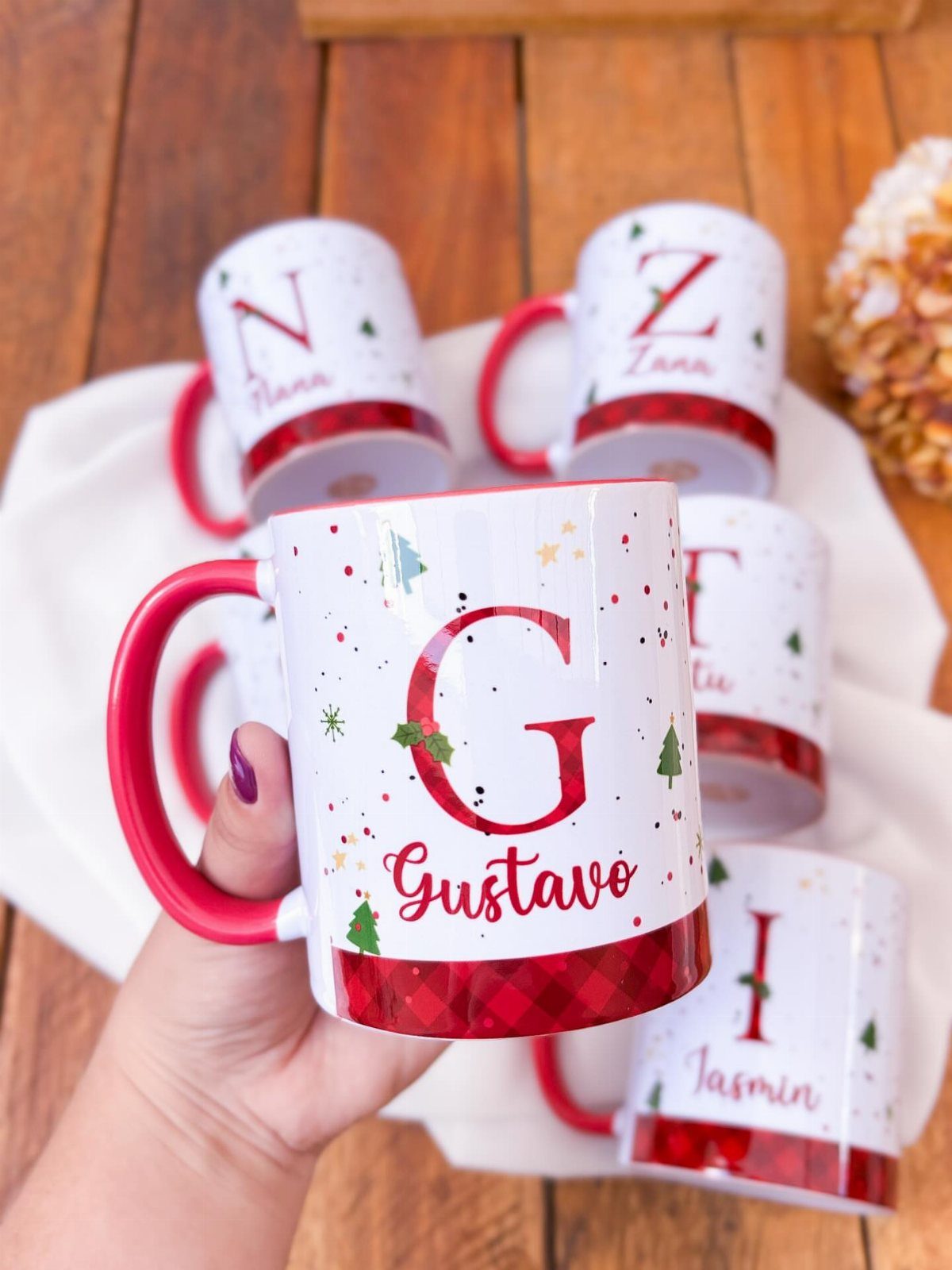 11 Christmas Gifts for Adults, From Waffle Makers to Desks 4 Personalized white ceramic mugs with red monogram letters and names on a wooden table