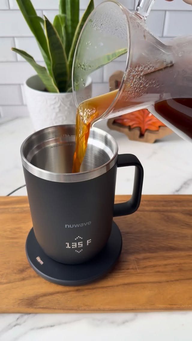 11 Christmas Gifts for Adults, From Waffle Makers to Desks 8 Coffee pouring into a black NuWave smart mug on a wooden board