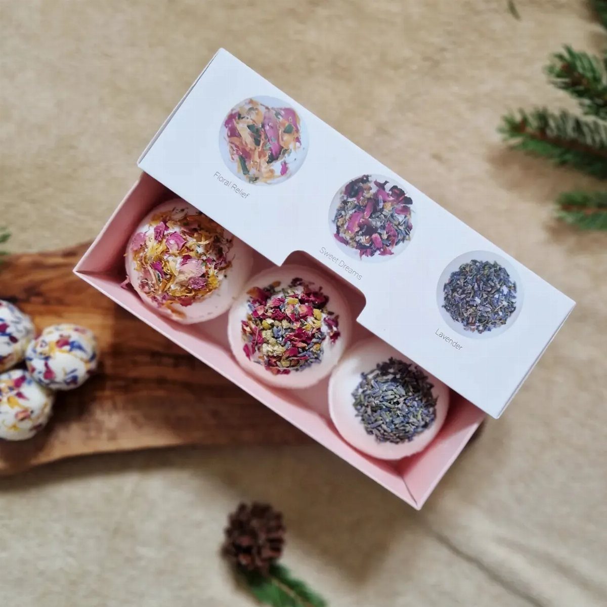 25 Christmas Gifts to Make at Home: Candles to Cookies 7 White bath bombs with dried flower petals in a pink gift box