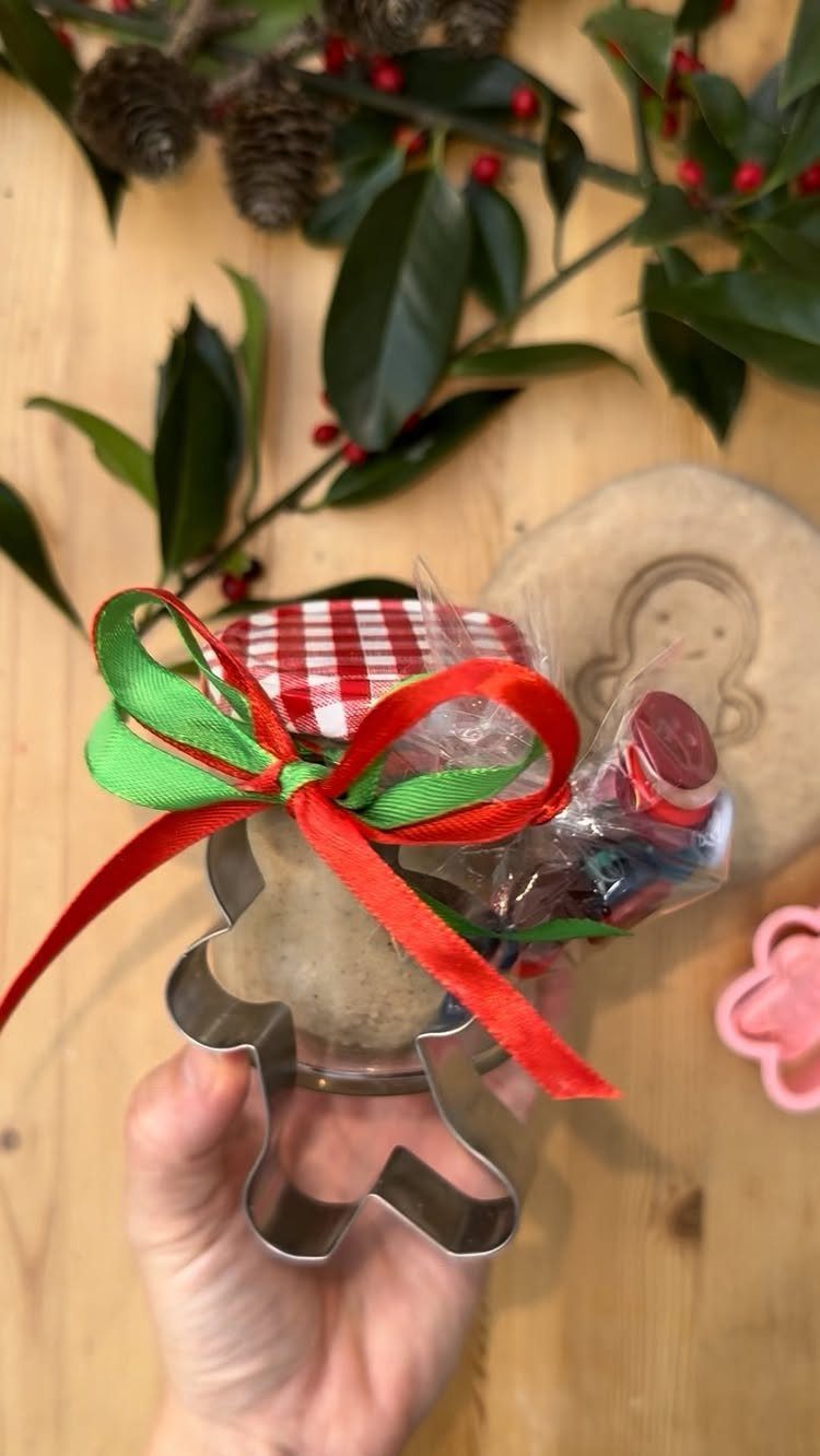 25 Christmas Gifts to Make at Home: Candles to Cookies 24 Gingerbread man cookie cutter filled with baking ingredients and tied with festive ribbons.