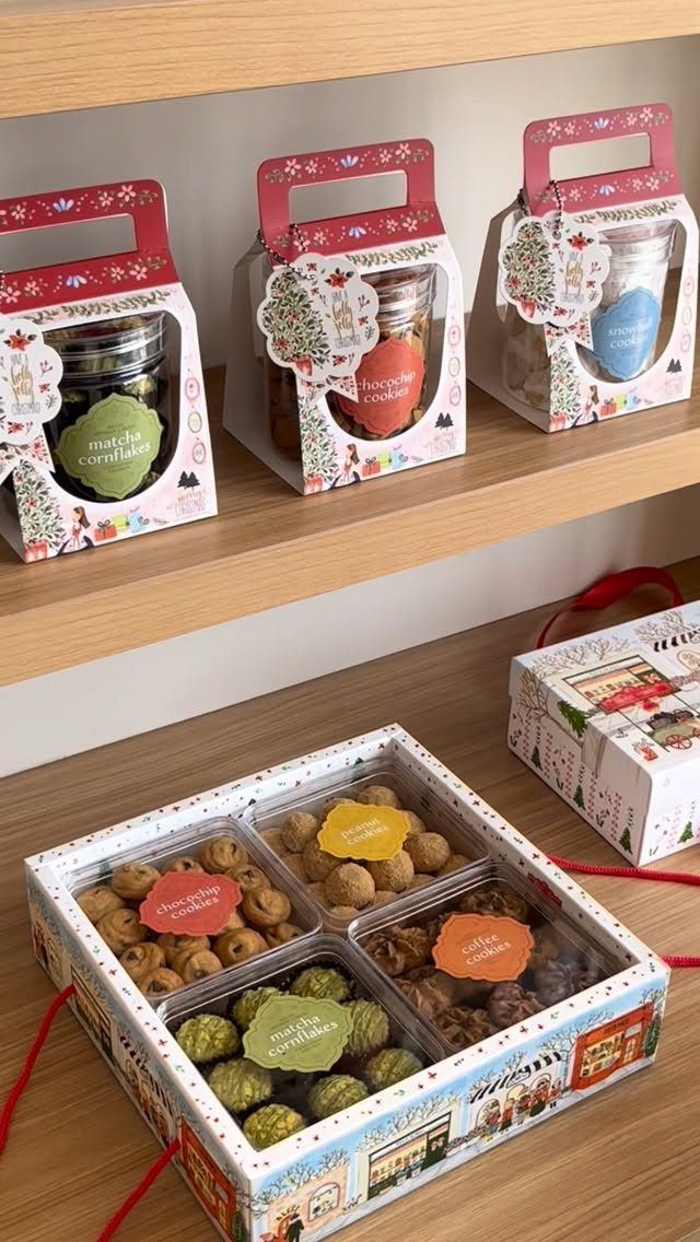 25 Christmas Gifts to Make at Home: Candles to Cookies 9 Assorted cookies in decorative jars and a divided gift box on wooden surfaces.