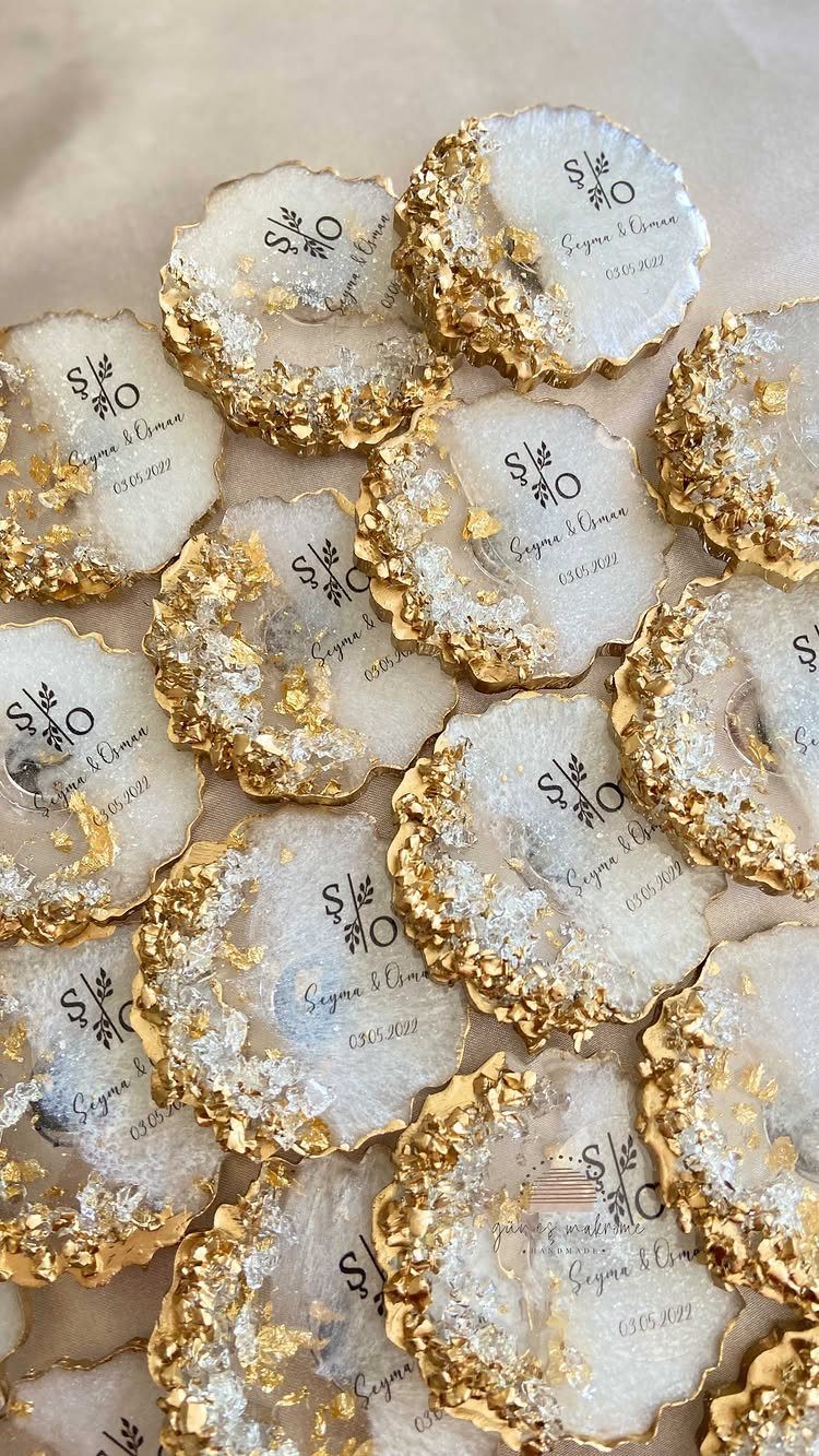 25 Christmas Gifts to Make at Home: Candles to Cookies 12 White geode coasters with gold edges and personalized black text on beige fabric.