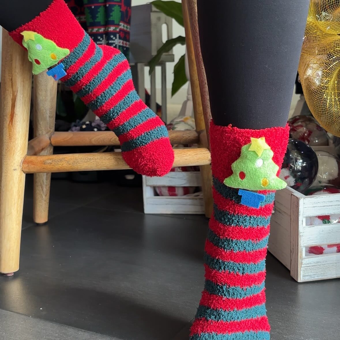 Christmas Stocking Gifts: 8 Small Ideas, Socks to Puzzles 5 Red and green striped fuzzy socks with Christmas tree appliques on a person