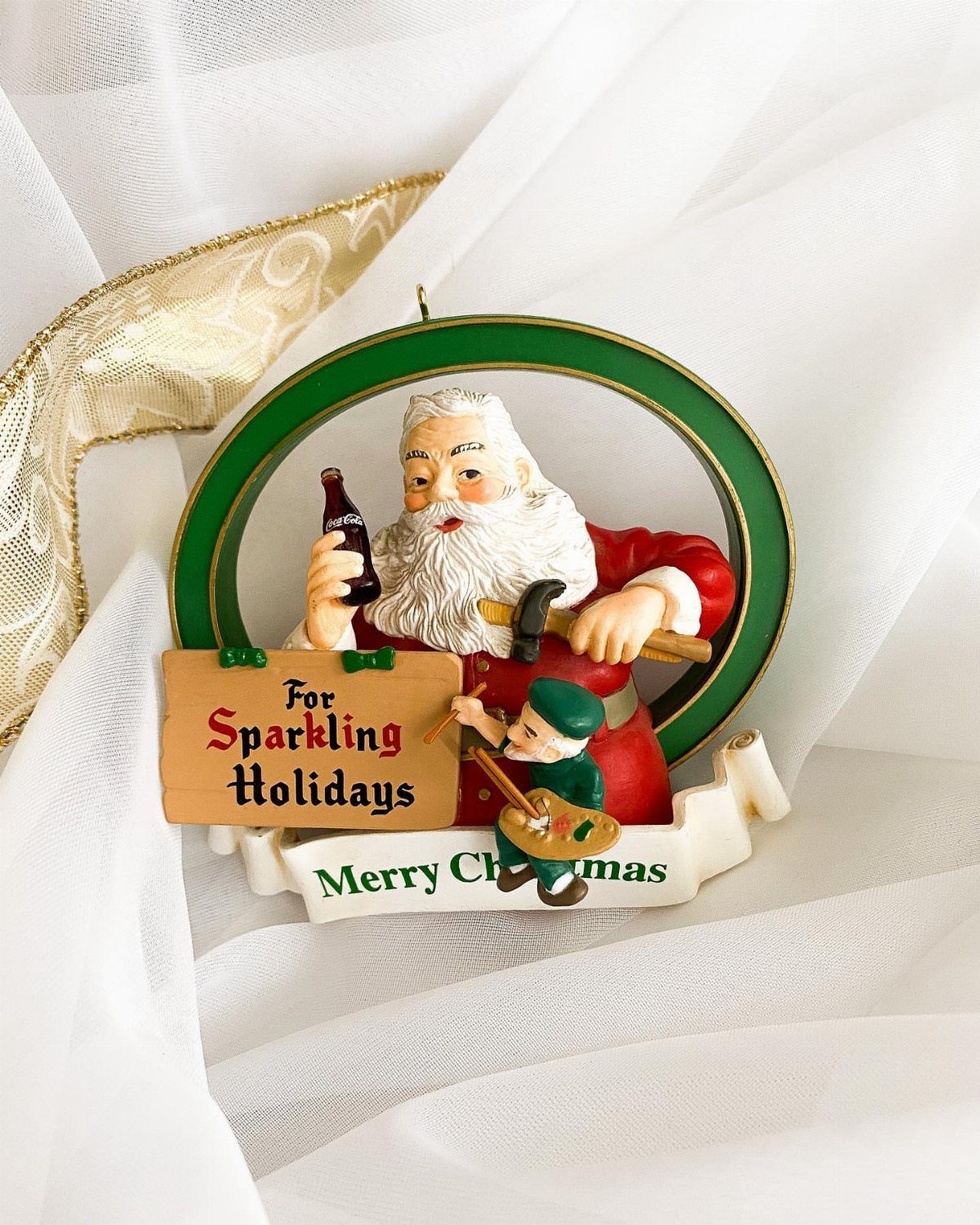 Coca-Cola Christmas Gift Ideas: 7 Picks for Fans 1 Santa Claus ornament holding a Coca-Cola bottle with a small elf playing banjo.