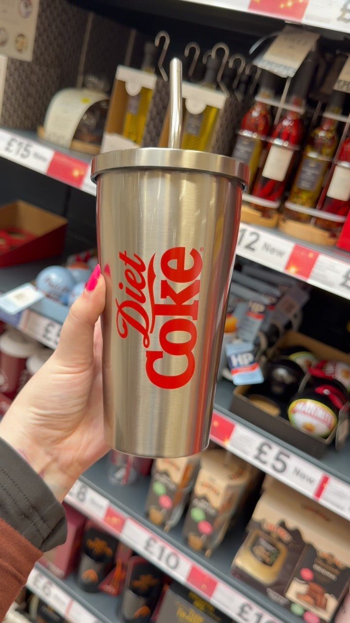 Coca-Cola Christmas Gift Ideas: 7 Picks for Fans 5 Stainless steel Diet Coke tumbler with red logo held in a store aisle.