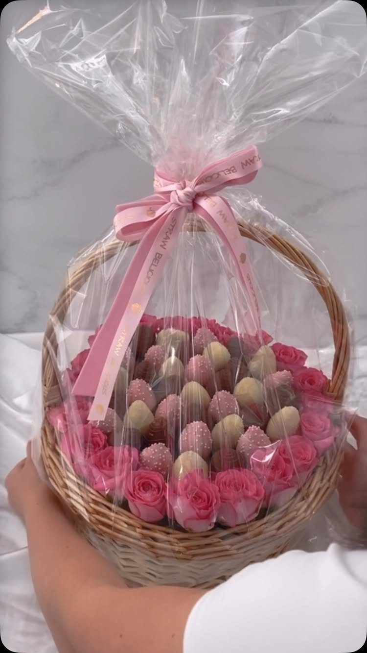 10 Cozy Gift Basket Ideas, from Spa Sets to Pumpkin Spice 5 Wicker basket filled with chocolate strawberries and pink roses wrapped in clear cellophane.