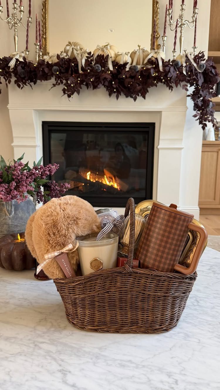 10 Cozy Gift Basket Ideas, from Spa Sets to Pumpkin Spice 10 Wicker gift basket with teddy bear, candle, and mug before a cozy fireplace.