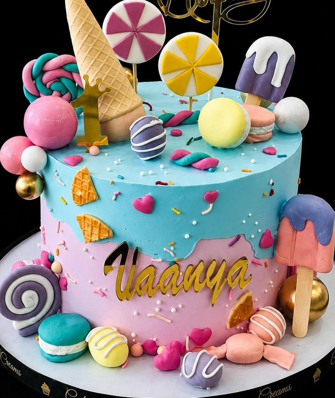 17 Creative Birthday Gifts for Friends and Family 6 Colorful candy cake with blue and pink frosting, topped with sweets and gold lettering.