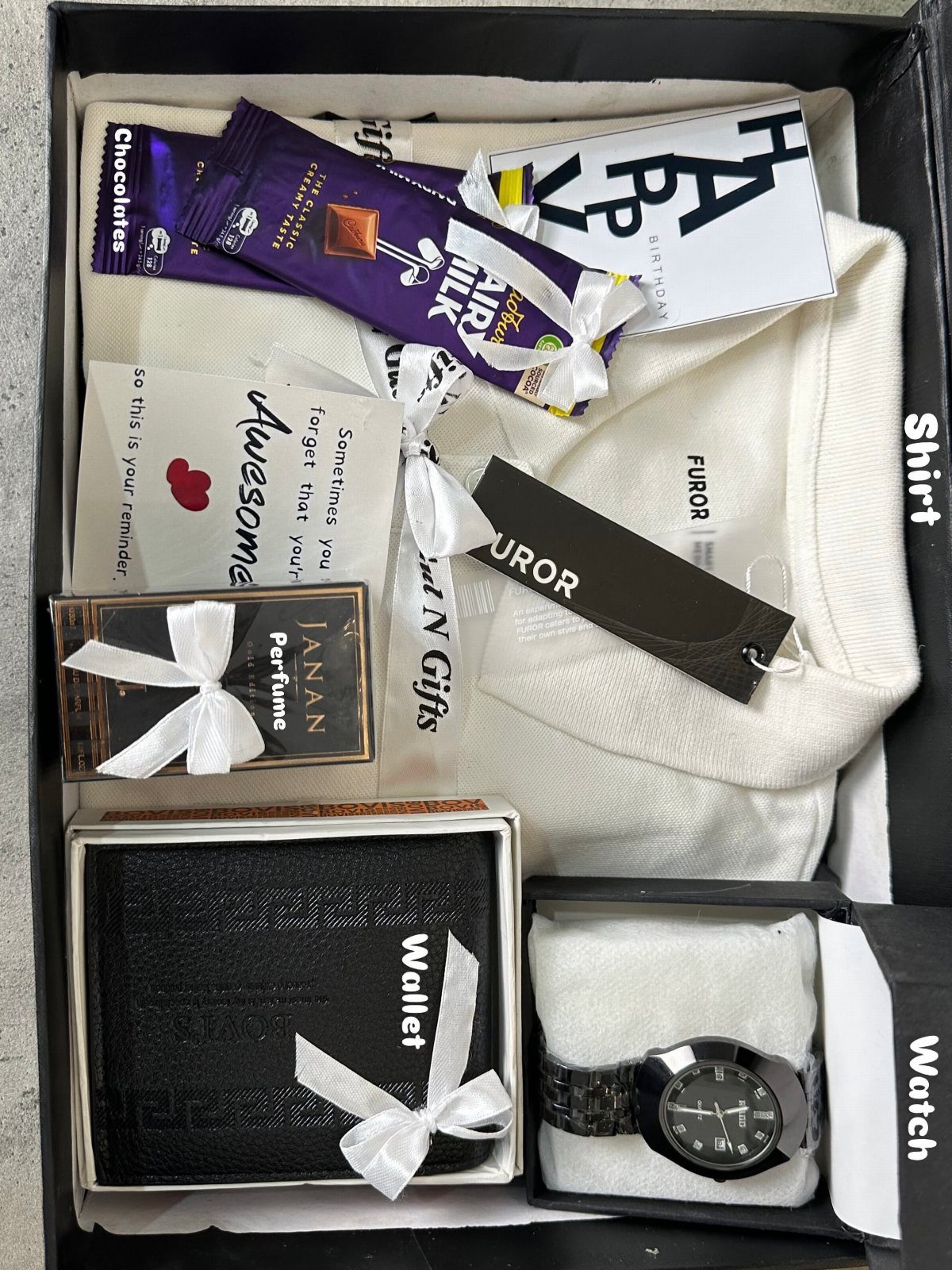 17 Creative Birthday Gifts for Friends and Family 15 Curated gift box with white shirt, black watch, wallet, perfume, and chocolates.
