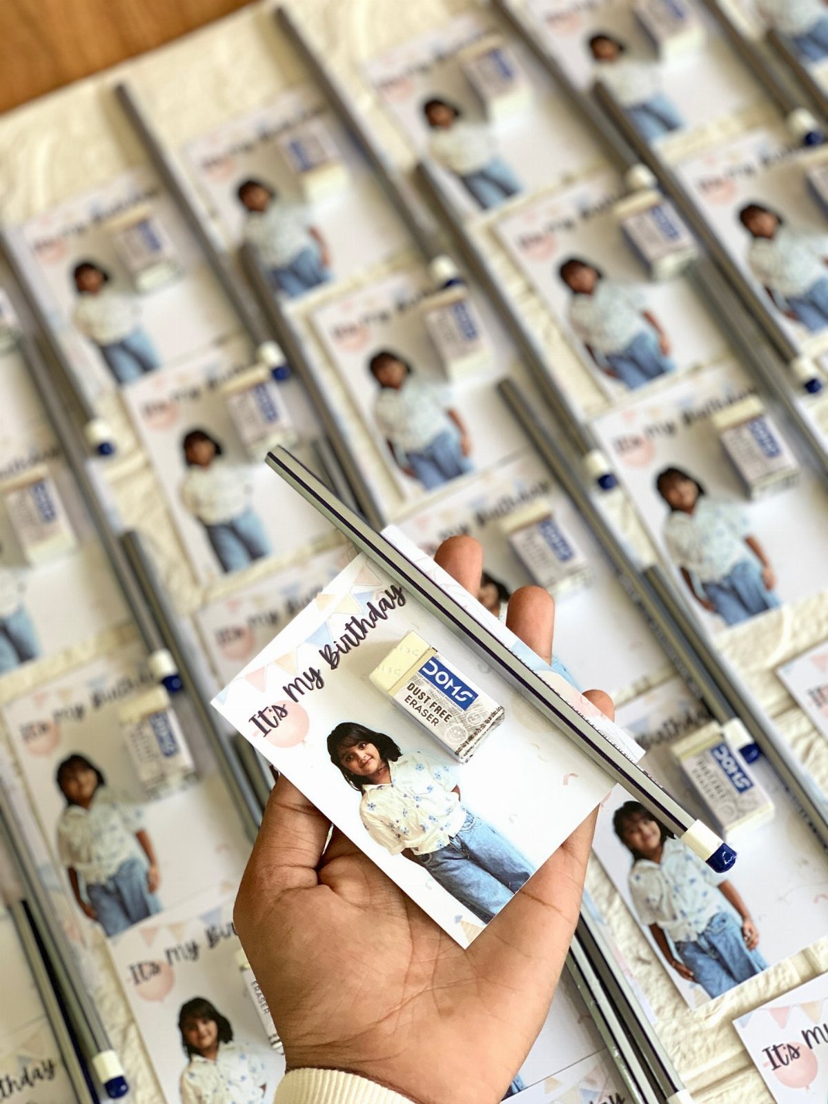 17 Creative Birthday Gifts for Friends and Family 2 Personalized birthday stationery sets with photos, erasers, and pens on a white surface.
