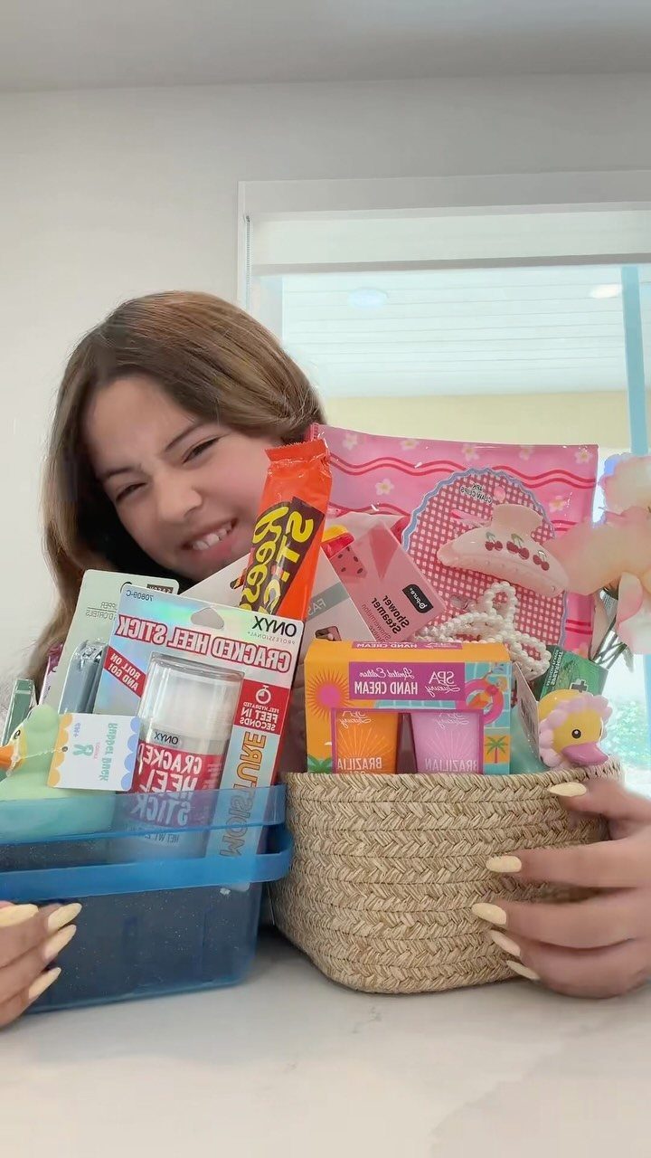Easter Gift Box Ideas: 6 Options From Baskets to Bakery 1 Woven wicker basket filled with colorful treats and beauty products held by a woman