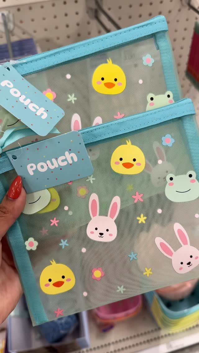 Light blue mesh pouches with Easter animals held by a hand with red nails.