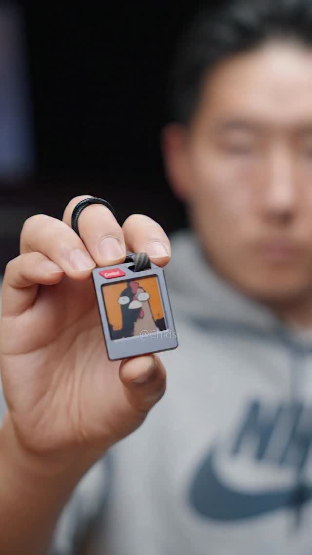 10 Easter Gifts for Young Adults They'll Actually Use 9 Hand holding a small polaroid keychain with a blurred man in background