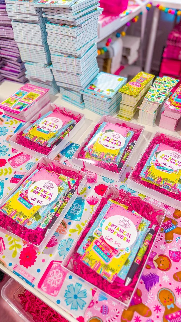 Stationery gift sets in clear boxes with pink filler and colorful notebooks.