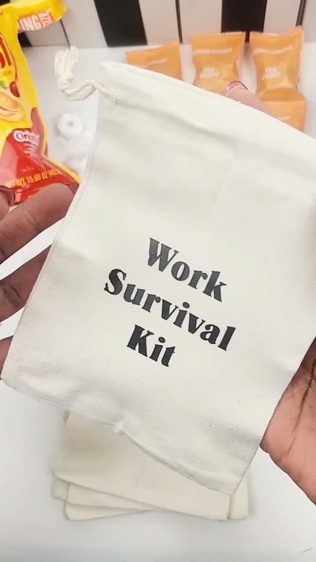 White fabric drawstring bag labeled Work Survival Kit held by two hands.