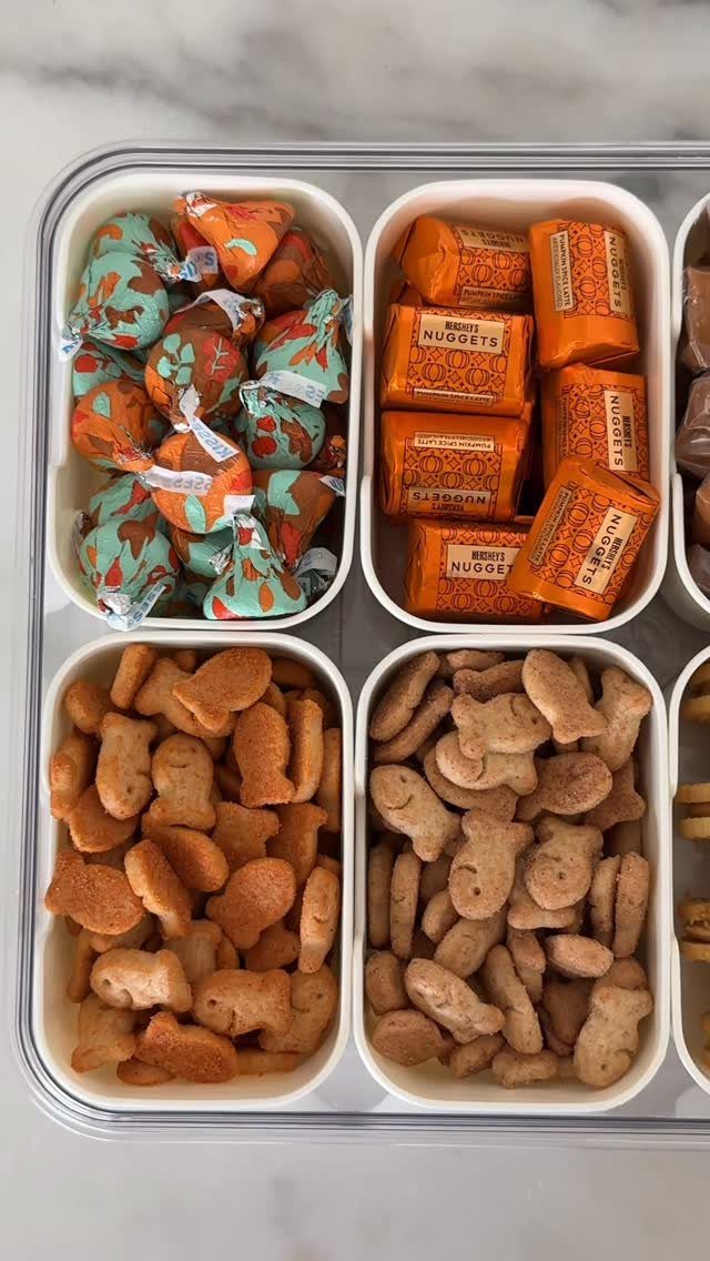 Divided white snack box filled with fish crackers and orange seasonal candies.