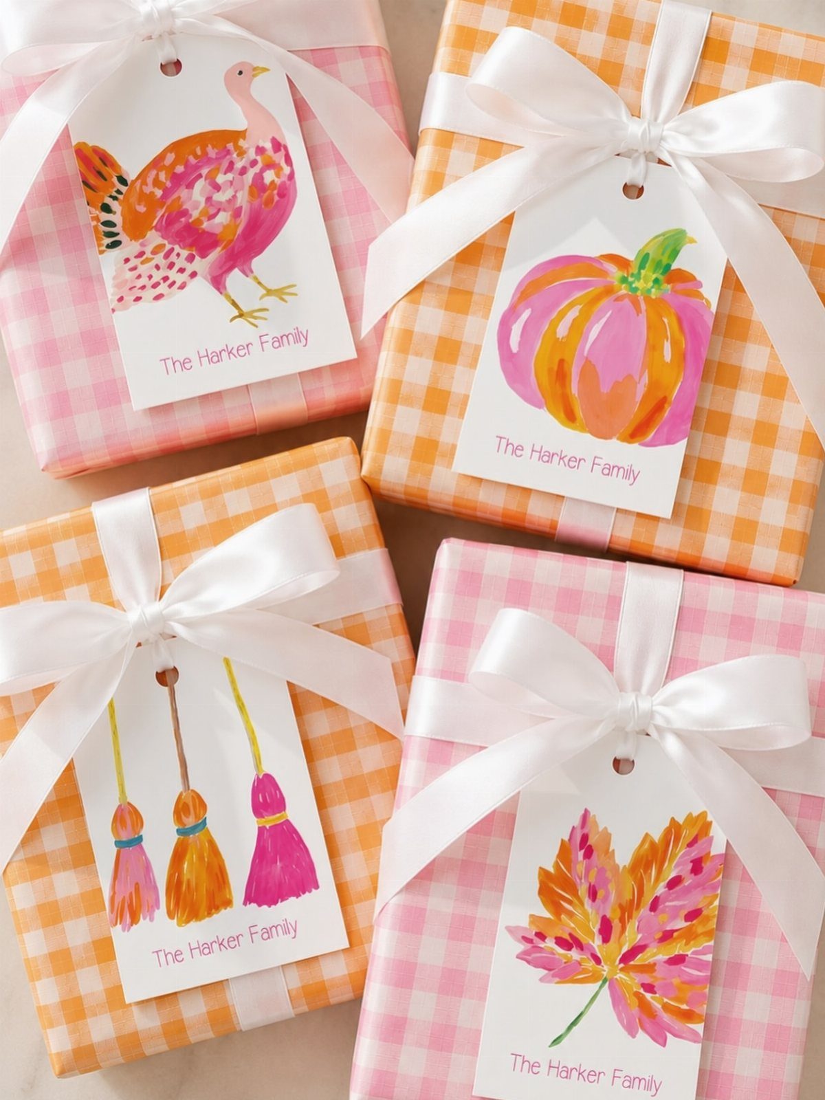 13 Fall Gifts for Women, From Cozy Socks to Cookbooks 5 Four gingham wrapped gifts with personalized tags featuring autumn illustrations and family name.