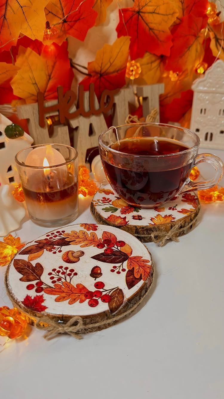 8 Fall Inspired Gifts for Cozy Autumn Gatherings 8 Tea cup on a rustic autumn leaf coaster with a lit candle nearby.