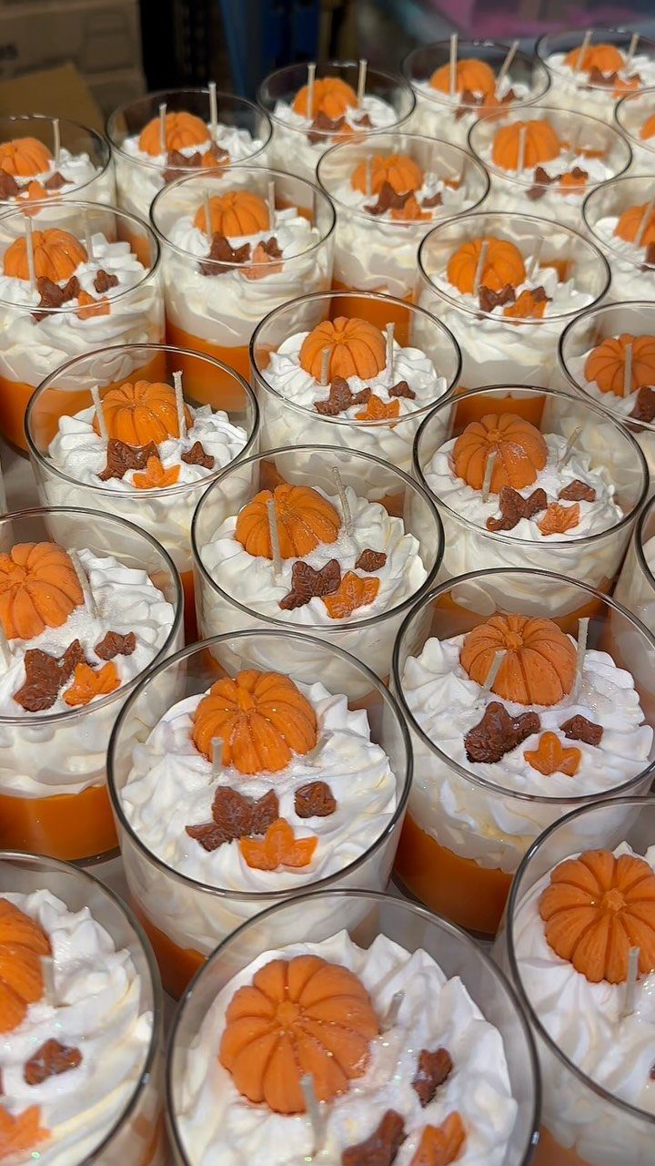 8 Fall Inspired Gifts for Cozy Autumn Gatherings 2 Pumpkin spice candles in glass jars with whipped wax and pumpkin toppers.