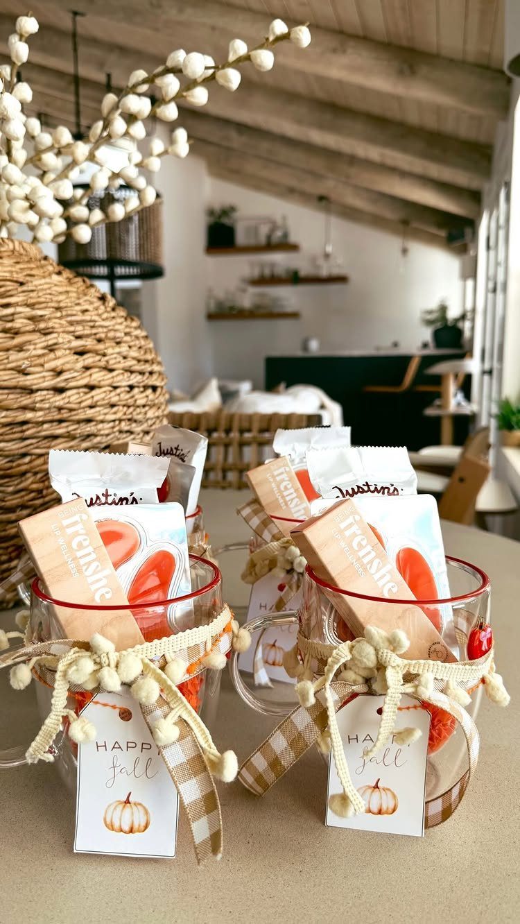 Two glass mugs filled with fall treats and tied with checkered ribbons.