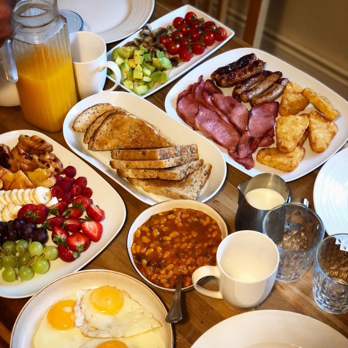 8 Father's Day Gift for Employees Ideas Dads Will Use 3 Breakfast spread with eggs, bacon, fruit, and orange juice on a wooden table