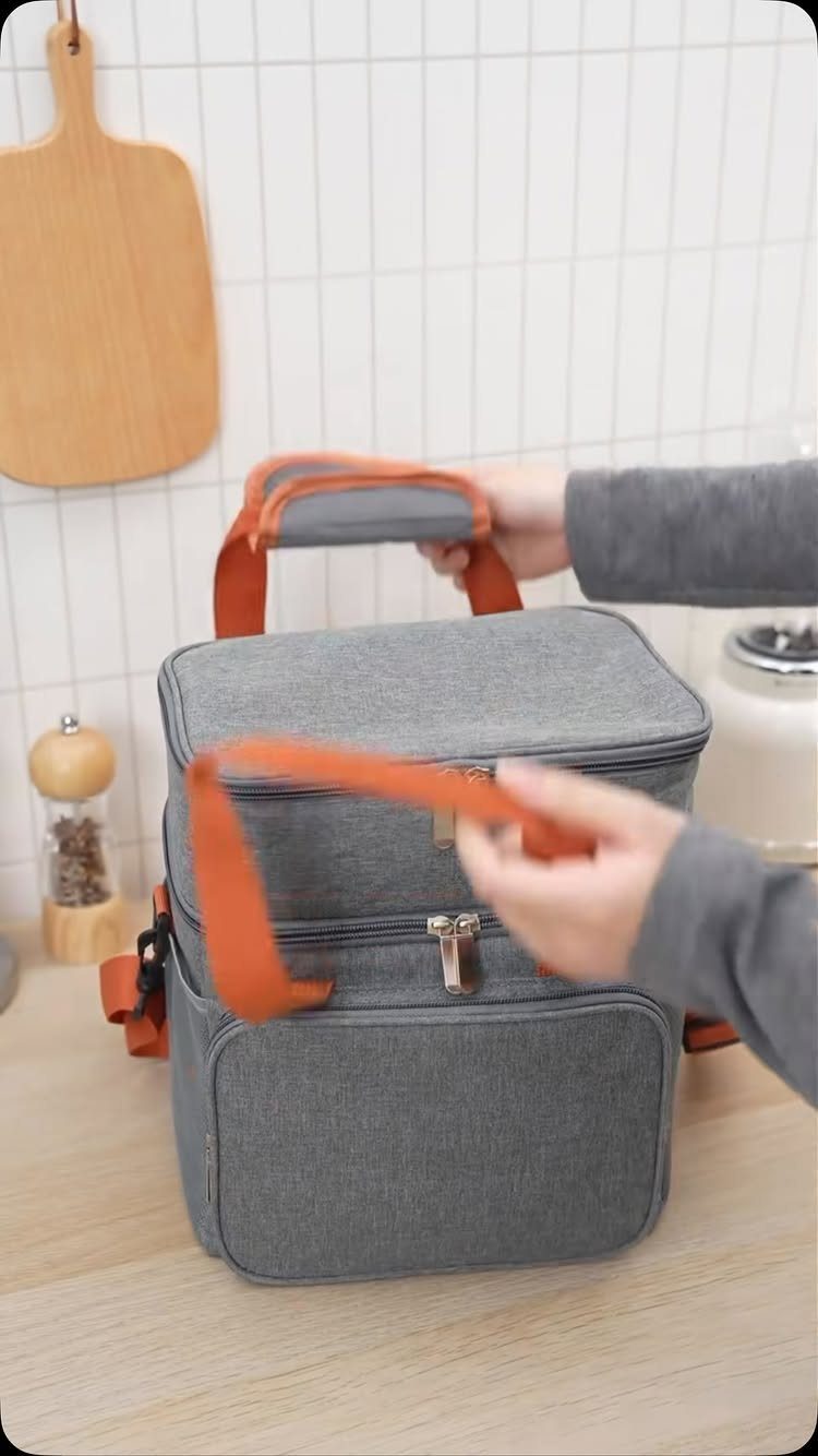 8 Father's Day Gift for Employees Ideas Dads Will Use 6 Grey insulated lunch bag with orange handles on a wooden kitchen counter