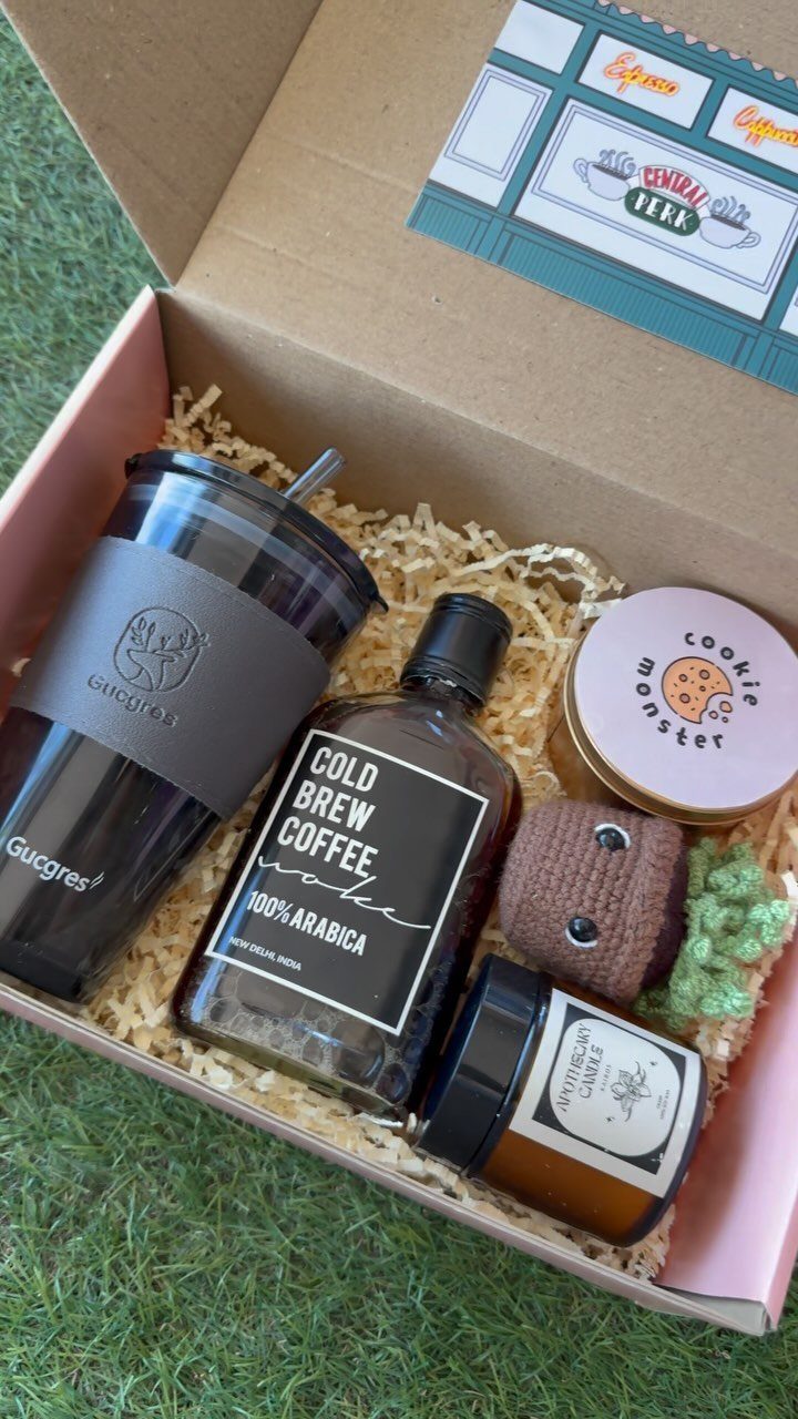 Gift box with cold brew coffee, honey, cookies, and a black tumbler
