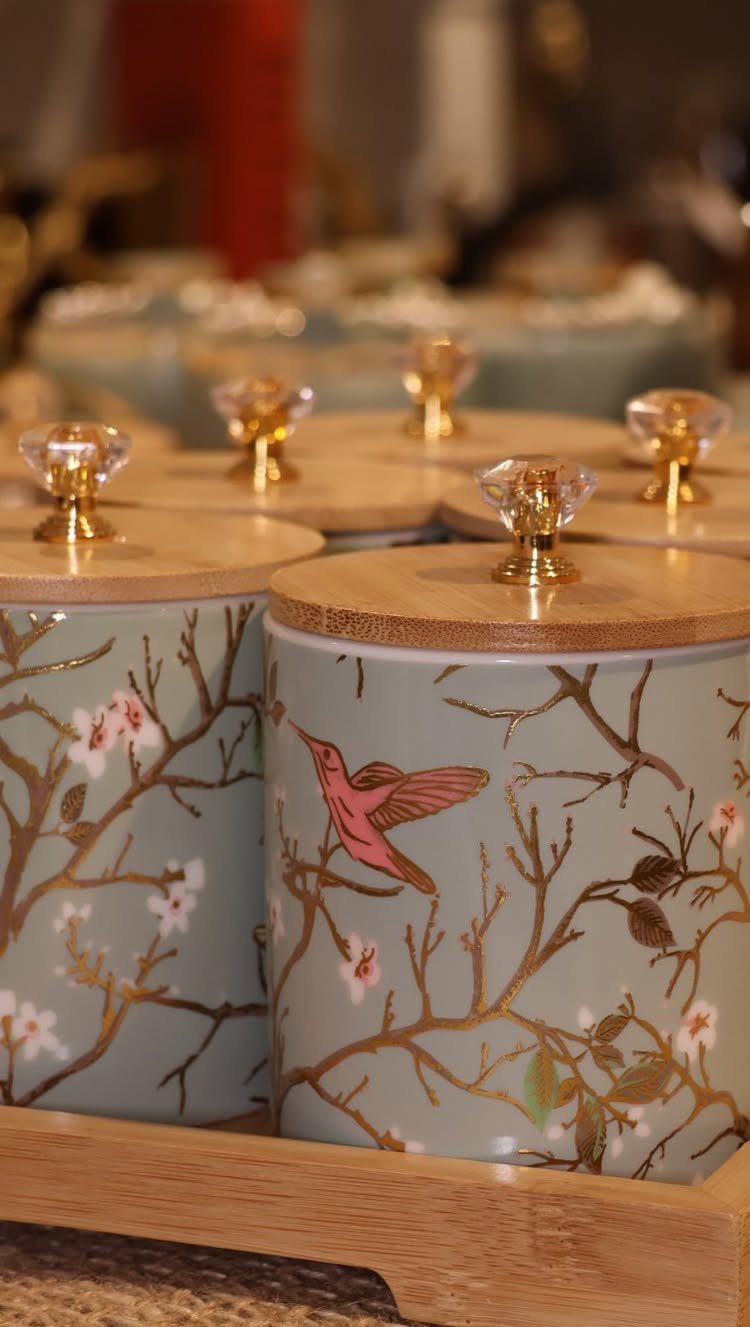 15 Friendsgiving Gift Ideas for Hosts and Guests 15 Light blue canisters with hummingbird and floral designs on a wooden tray