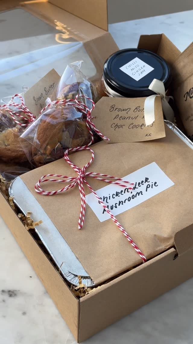 15 Friendsgiving Gift Ideas for Hosts and Guests 9 Homemade food gift basket with a pie, cookies, and a jar in a box.