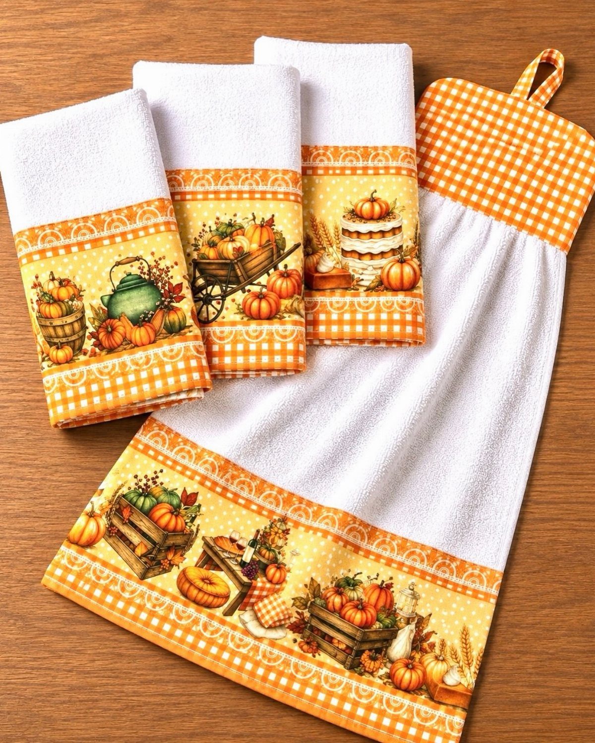 15 Friendsgiving Gift Ideas for Hosts and Guests 4 White kitchen towels with orange gingham borders and autumn pumpkin harvest prints.
