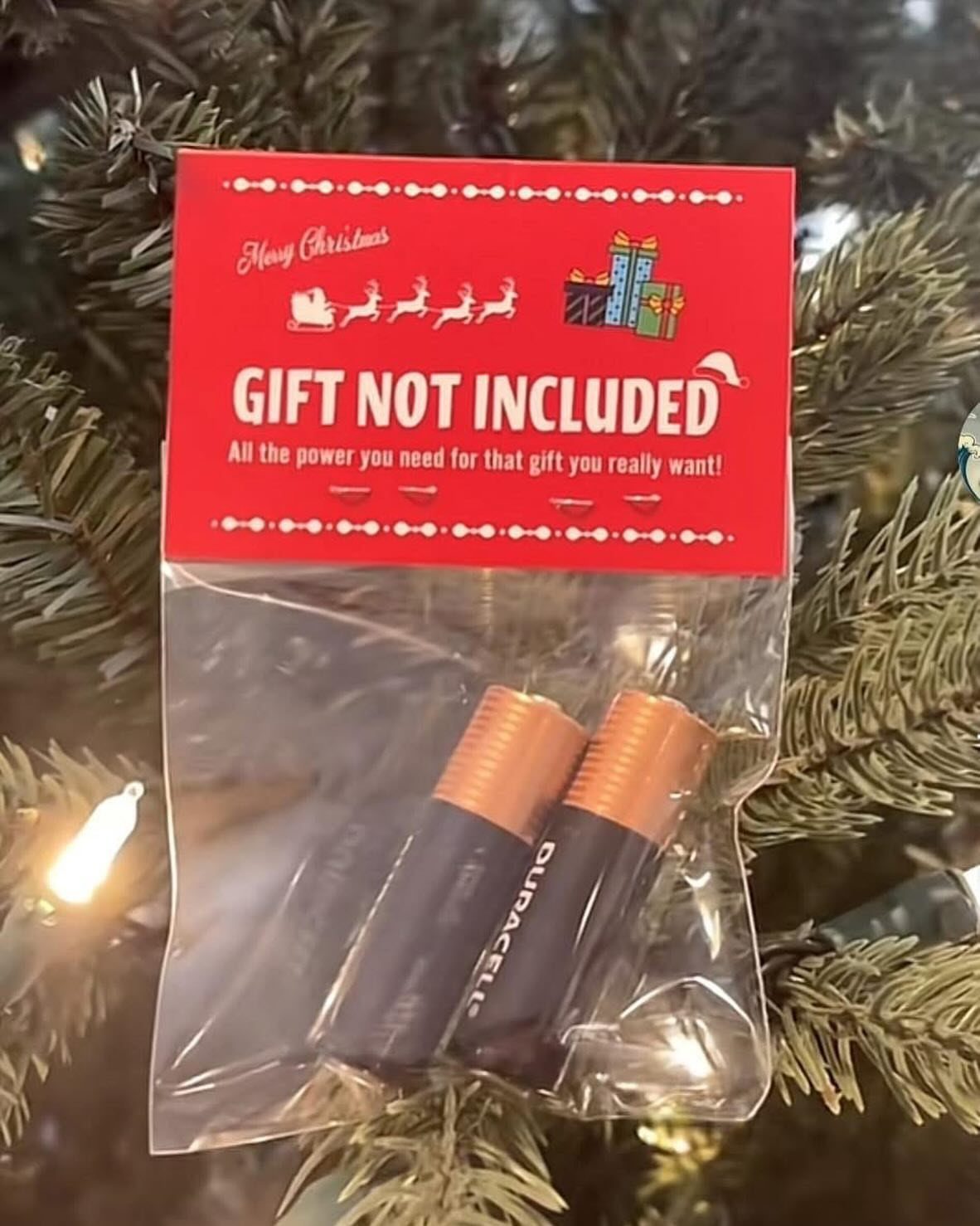 9 Funny Christmas Gift Wrapping Ideas Your Family Will Love 7 Two batteries in a clear bag with a red gift not included header.