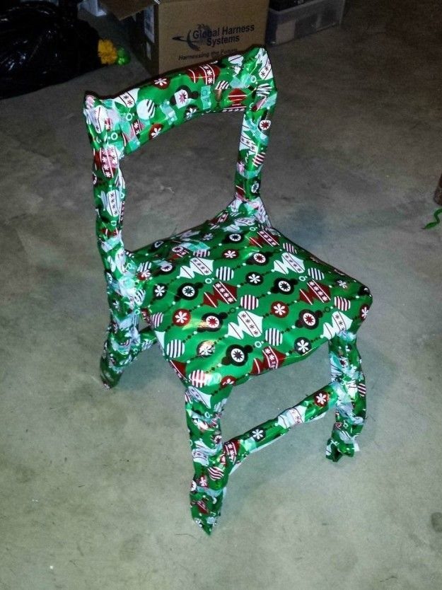 9 Funny Christmas Gift Wrapping Ideas Your Family Will Love 5 Chair wrapped in green festive Christmas wrapping paper on a concrete floor