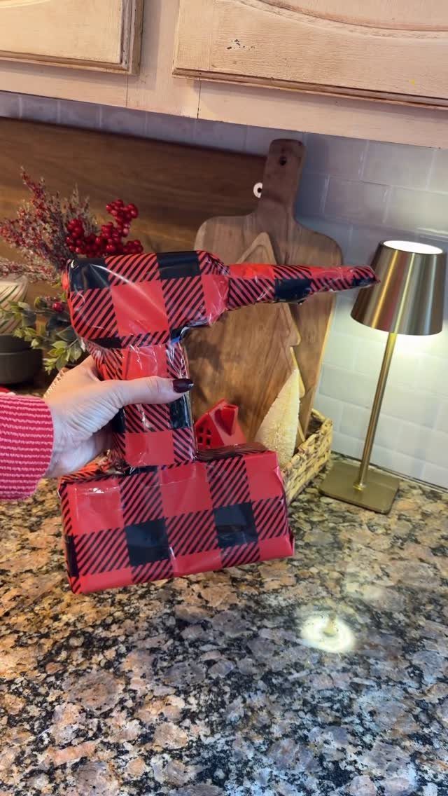 9 Funny Christmas Gift Wrapping Ideas Your Family Will Love 2 Power drill wrapped in red and black plaid paper held over a box.